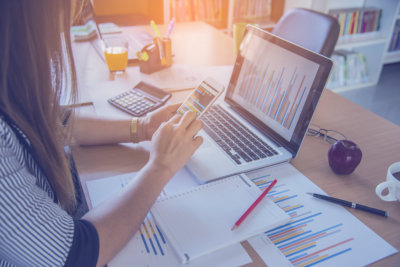business man hand working on smart phone and laptop