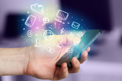 Hand holding smartphone with glowing multimedia icons