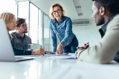 Businesswoman standing and leading business presentation